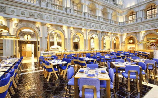 Sixth and Mill restaurant interior with marble arches and blue seating